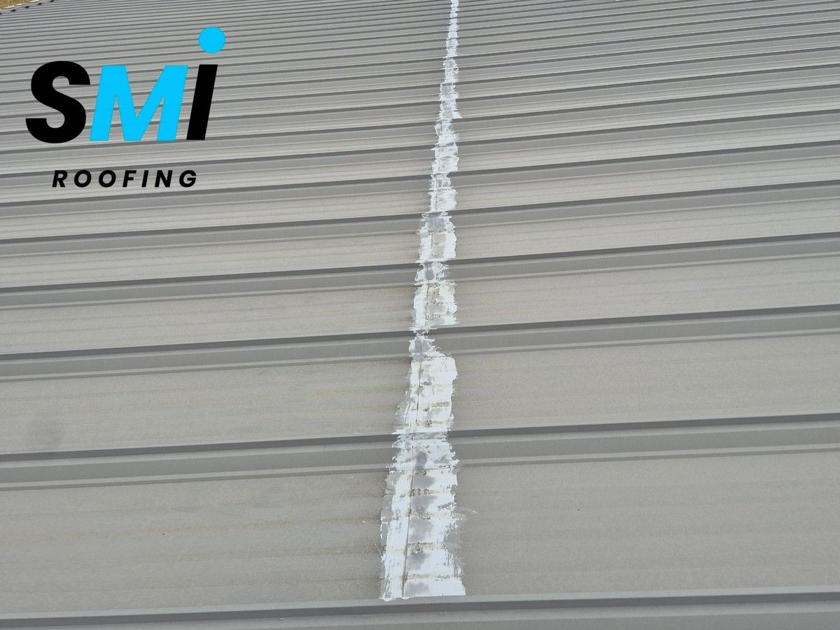 Sealed seam repair on a commercial metal panel roof, part of pre-winter roof maintenance in the Arkansas River Valley